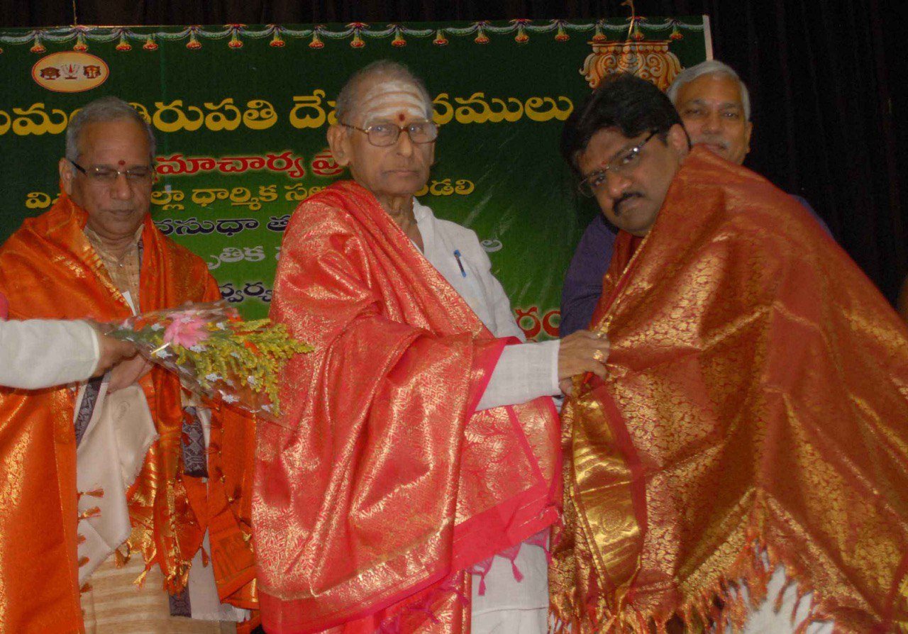 Dr. Tyagaraj being felicitated by Dr. Nedunuri Krishnamurthy